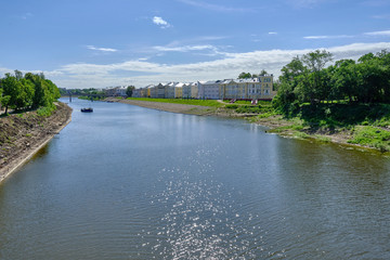 Fototapeta na wymiar Scenic view of river in ancient touristic town Vologda in Russian Federation. Beautiful summer sunny look of water in urban area of capital of russian province