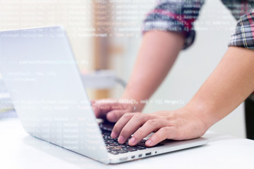 close up computer programmer man hand typing configuration on keyboard at laptop for input coding language to software for fix bug and defect of system in data center room , engineering and technology