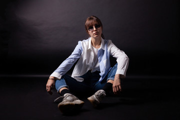 Caucasian Girl in white shirt posing in the studio