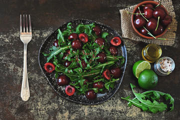 Fototapeta na wymiar Healthy dietary salad with sweet cherries and arugula. Fitness salad. Raw diet.