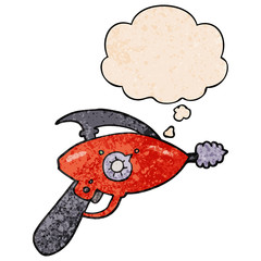 cartoon ray gun and thought bubble in grunge texture pattern style
