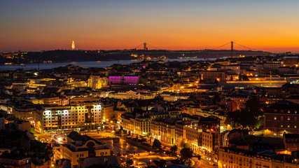 Fototapeta na wymiar Panorama of Cityscape of illuminated Lisbon (Lisboa) Portugal, from a viewpoint, after summer sunset against sky.