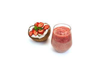 coconut cut with banana and strawberry slices with mint  and strawberry two-layer cocktail in a glass on white background