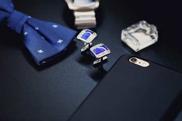 Luxury blue fashion men`s cufflinks. accessories for tuxedo, butterfly, tie and smartphone with screen