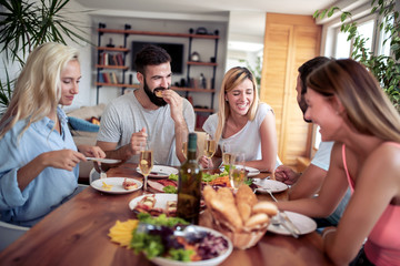Group of happy friends having lunch