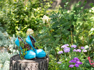 Worn out blue second hand stilettos / high heels upcycled into eco friendly planters / flowerbeds /...