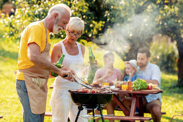 Senior couple make barbecue