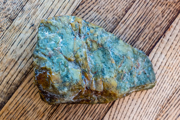Colorful rainbow stone on rustic wood background