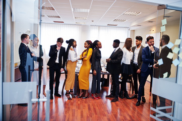 Fototapeta na wymiar Large group of eleven multiracial business people standing at office. Diverse group of employees in formal wear.