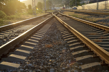 Fototapeta premium railroad going into the distance into the golden sunset