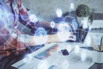 Double exposure of technology hologram with man working on computer background. Concept of big data.