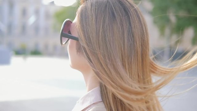 Business woman walking in the city. Portrait of stylish confident female