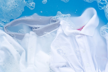 Shirt soak in powder detergent water dissolution. Laundry concept