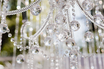 Blur and Defocus Crystal Chandelier Shiny Glitter. Elegant Element of Room Interior for Celebrating Anniversary of Birthday or Wedding Day Party. Detail of Decoration on Abstract Background