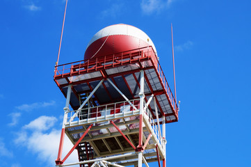 Red and white Water Tower on blue sky background