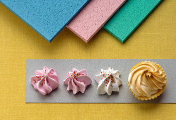 A pic of meringues in a row with a colourful background