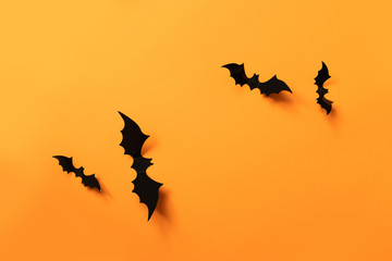 Halloween banner with black bats on an orange background, top view