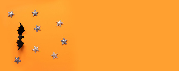 Halloween banner with black but on an orange background, top view.