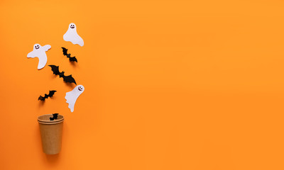 Halloween flat composition of orange pumpkin, black bats, white paper cast