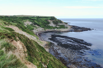 Obraz premium Port Mulgrave bay and jetty, North Yorkshire, UK. Viewed from the Cleveland Way walk from Runswick Bay to Staithes.
