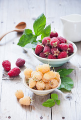 Fresh organic white gold and red raspberry in a bowl 