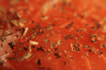 Macro photo of salmon. Fresh red fish, white veins, rich color. Fish seasoned in spices, dried basil, salt, pepper.