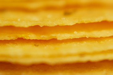 Spiced Homemade Potato Chips. Macro shooting chips. Very close up. Chips from the oven only, rosy chips, chips with cheese, bacon. Long Chips Stripe