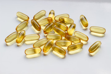 yellow vitamin pills isolated on white background omega 3 fish oil