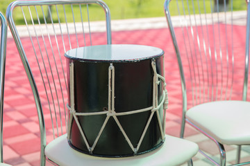 Fototapeta na wymiar Azeri traditional drum nagara on black .Black Drum on the chair