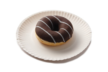 Sweet doghnut in glaze decorated with sprinkles on a paper plate isolated on a white background