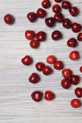 Red sweet cherry scattered on a white wooden table