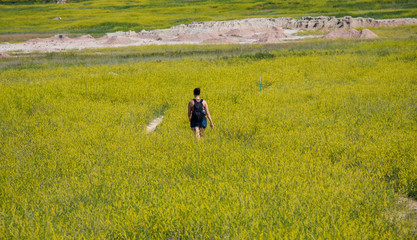 Woman Walking in Yellow Meadow