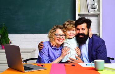 Elementary student. Kids gets ready for school. Learning and education concept. Teachers day. Education for children out of school. Couple helping his son to make homework. September 1. Family school.