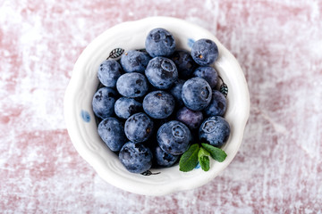 handful of blueberries in ceramic bowl