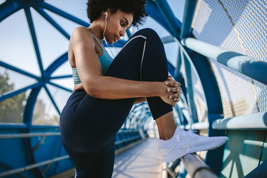Athlete stretching legs before a run