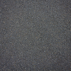 tiny beach stones of volcanic origin with a variety of rounded shapes and gray colors as a background texture