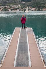 Girl standing on the  pier