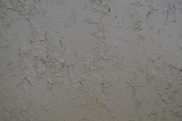 Texture of iron metal painted gray peeling paint of old battered scratched cracked ancient rusty metal sheet wall with corrosion. The background
