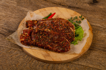 Raw marinated pork steak