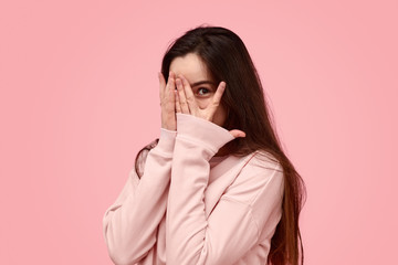 Shy teenager hiding face