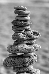 BEACH STONES STACKED WITH HORIZON OF SEA AND HEAVEN