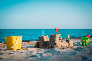 Sand castle on beach vacation and toys