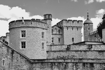 The famous White Tower and the Tower of London from South Bank across the River Thames. Popular historical tourist attraction on a summer day.