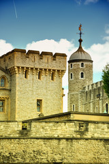 The famous White Tower and the Tower of London from South Bank across the River Thames. Popular historical tourist attraction on a summer day.