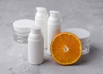 Set of cosmetic bottle containers with orange. Blank label for branding mock-up.