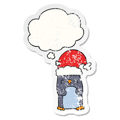 cartoon penguin and thought bubble as a distressed worn sticker