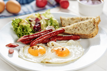 Egg Sausage Dish with Toast Salad Leaves Plate. Traditional Morning Fried Meal with Grilled Hunting Ham Side View. Delicious English Lunch. Tasty Home Cooked Gourmet Closeup. Eat Brunch