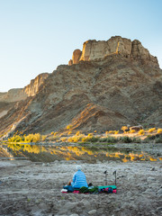 A hiker waking up in the Fish River Canyon of Namibia - 276795718