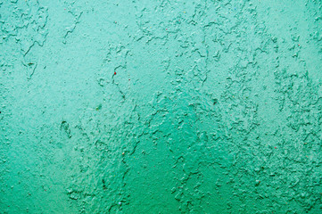 Obraz premium Texture of iron metal painted bright green peeling paint of old battered scratched cracked ancient rusty metal sheet wall with corrosion. The background