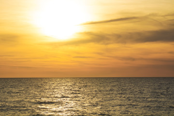 Beautiful fiery sunset sky on the beach. Sunrise over the sea and beautiful cloudscape.